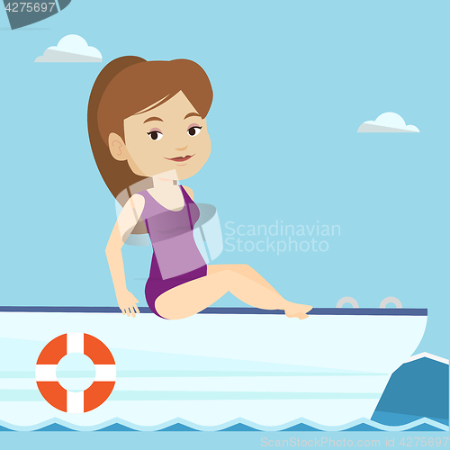 Image of Young happy woman tanning on sailboat.