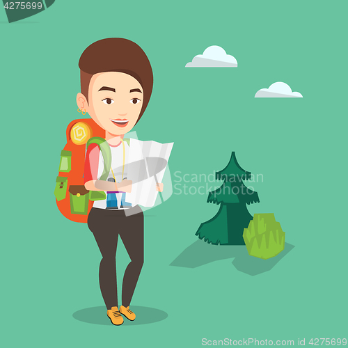 Image of Traveler with backpack looking at map.