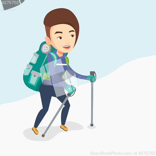 Image of Young mountaneer climbing a snowy ridge.