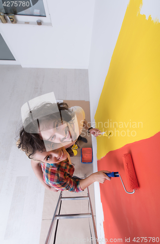 Image of couple painting interior wall