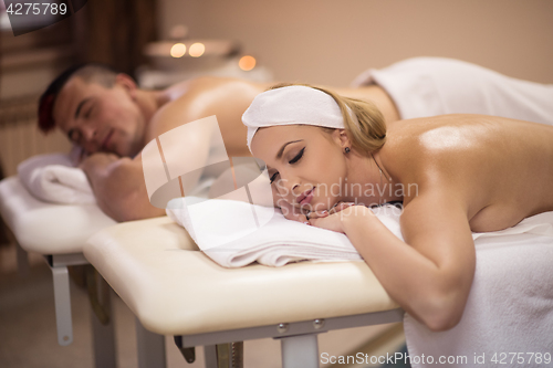 Image of young couple lying on massage table