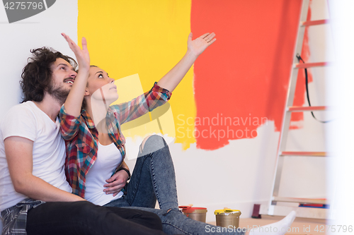 Image of Happy young couple relaxing after painting