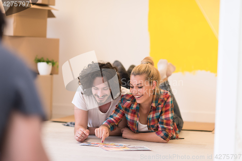 Image of Happy young couple relaxing after painting