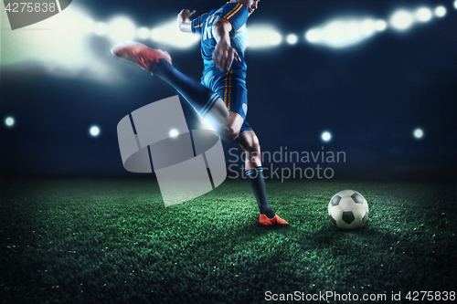 Image of The active player of football at stadium in motion
