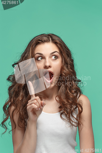 Image of Portrait of young woman with shocked facial expression