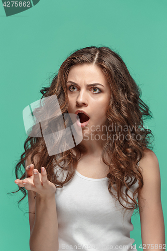 Image of Portrait of young woman with shocked facial expression