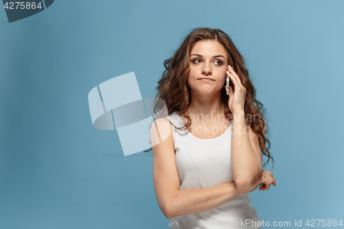 Image of The portrait of disgusted woman with mobile phone