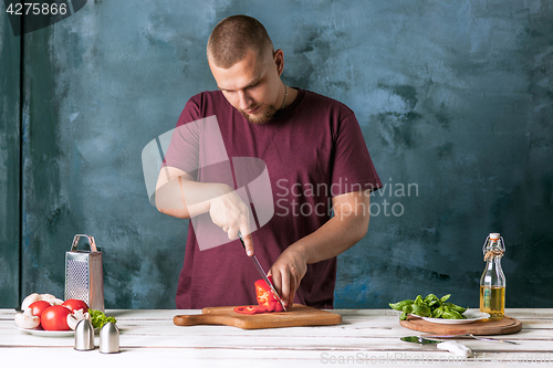 Image of Closeup hand of chef baker making pizza at kitchen