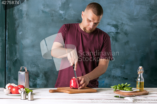 Image of Closeup hand of chef baker making pizza at kitchen