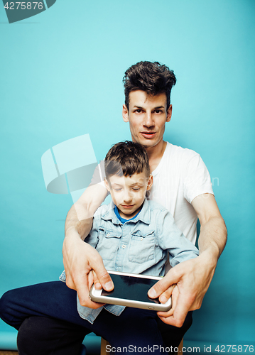 Image of young pretty man model with little cute son playing together, lifestyle modern people concept, family male