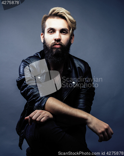 Image of portrait of young bearded hipster guy smiling on gray dark background close up, brutal modern man, lifestyle people concept