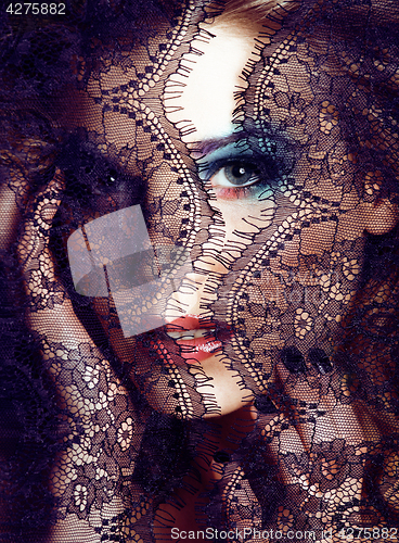 Image of portrait of beauty young woman through lace close up mistery makeup sexy, fashion people concept