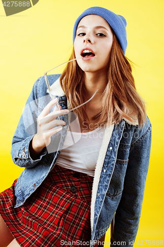 Image of lifestyle people concept: pretty young school teenage girl having fun happy smiling on yellow background close up