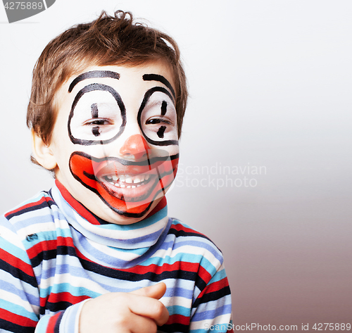 Image of little cute boy with facepaint like clown, pantomimic expression