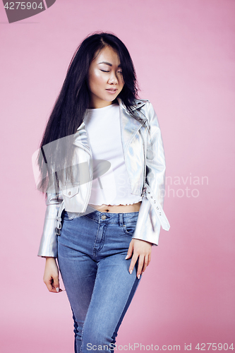 Image of young pretty smiling asian korean girl wearing modern fashion clothers on pink background, lifestyle people concept