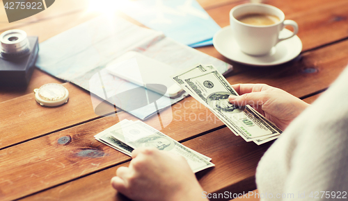 Image of close up of traveler hands counting dollar money