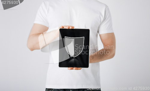 Image of man with antivirus program icon on tablet pc