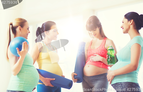 Image of group of happy pregnant women talking in gym