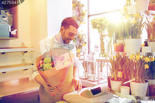 Image of florist man or seller at flower shop cashbox