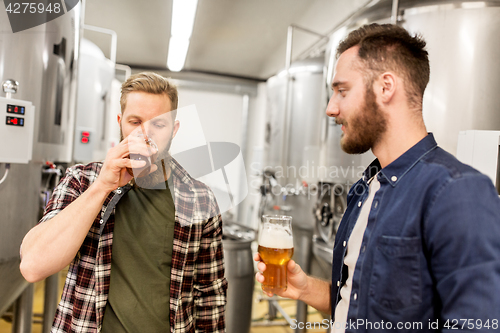 Image of men drinking and testing craft beer at brewery