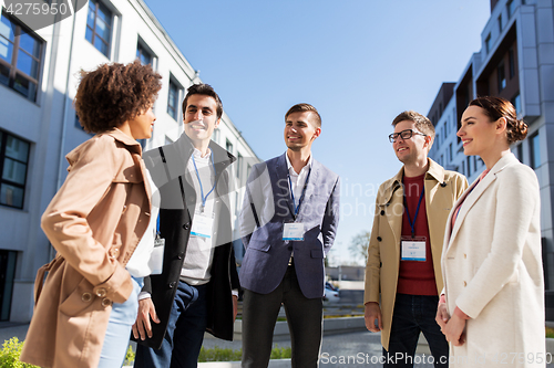 Image of business people with conference badges in city