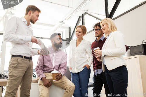 Image of business team with tablet pc and coffee at office