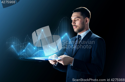 Image of businessman with tablet pc and virtual charts