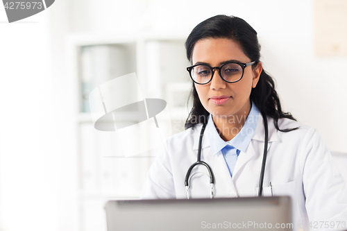 Image of female doctor with laptop at hospital