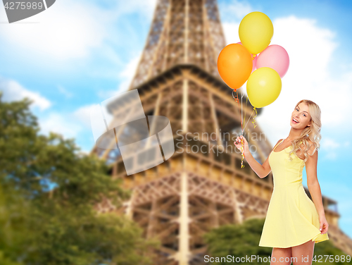 Image of happy woman with air balloons over eiffel tower