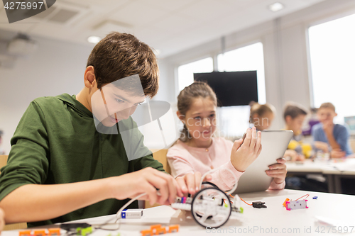 Image of kids with tablet pc programming at robotics school