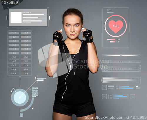 Image of woman with earphones listening to music in gym