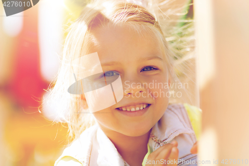 Image of happy little girl climbing on children playground