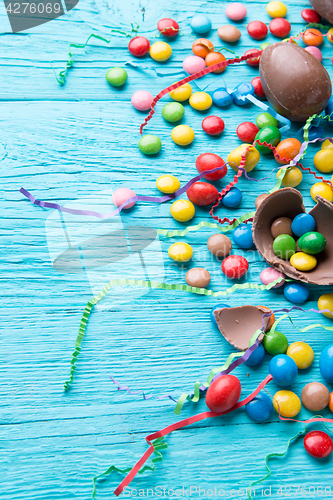 Image of Multicolored dragees, chocolate eggs, ribbons