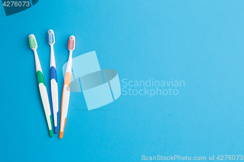 Image of Toothbrushes at empty blue background