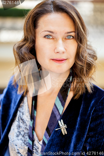 Image of beautiful woman with a dragonfly brooch