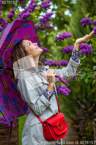 Image of smiling middle-aged woman with an umbrella 