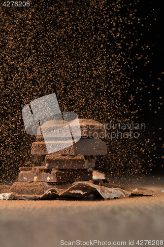 Image of Broken chocolate with sprinkled cocoa