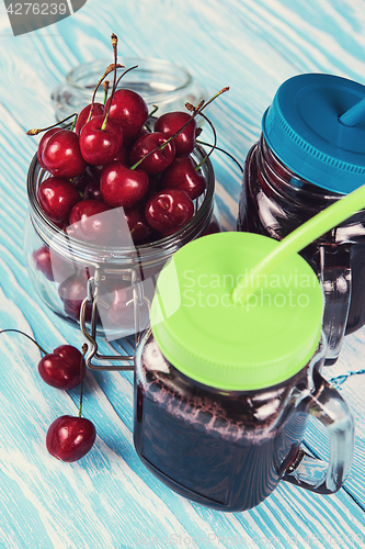 Image of Cherry juice with glass of berries
