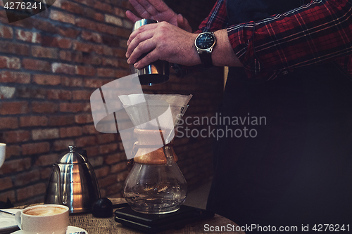 Image of Barista brewing coffee