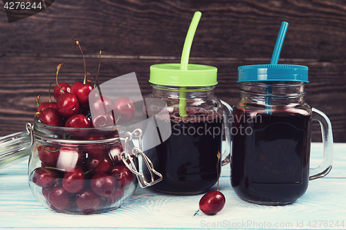 Image of Cherry juice with glass of berries