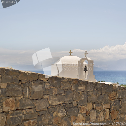 Image of Greek orthodox church behind the wall