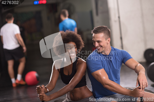 Image of multiethnic couple after workout with hammer