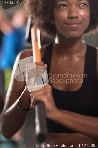 Image of black woman after workout with hammer