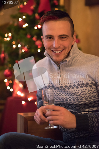 Image of Happy young man with a glass of champagne