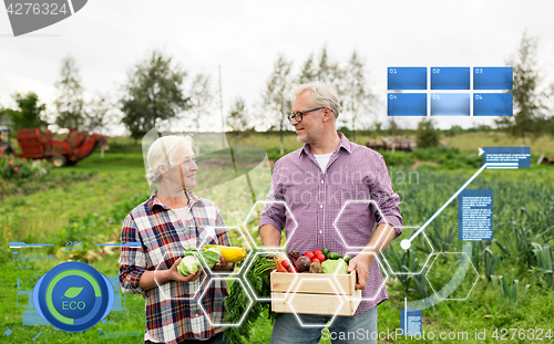 Image of senior couple with box of vegetables on farm