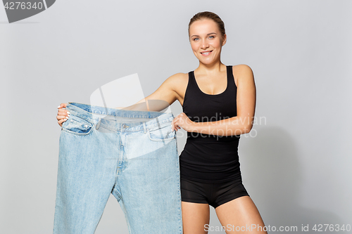 Image of young slim sporty woman with oversize pants