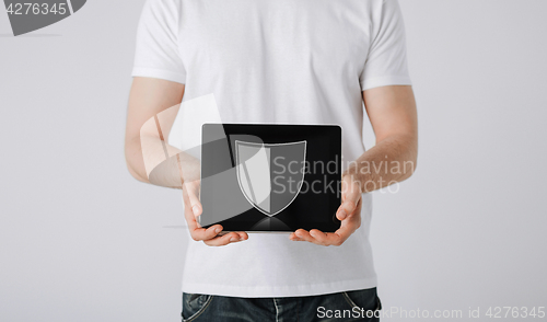 Image of man with antivirus program icon on tablet pc