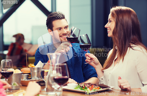 Image of couple dining and drinking wine at restaurant