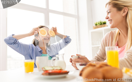 Image of happy family having breakfast at home kitchen