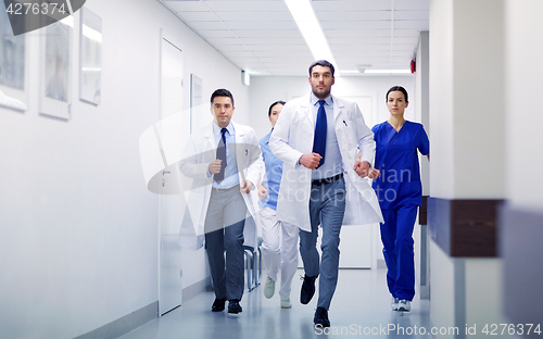 Image of group of medics walking along hospital